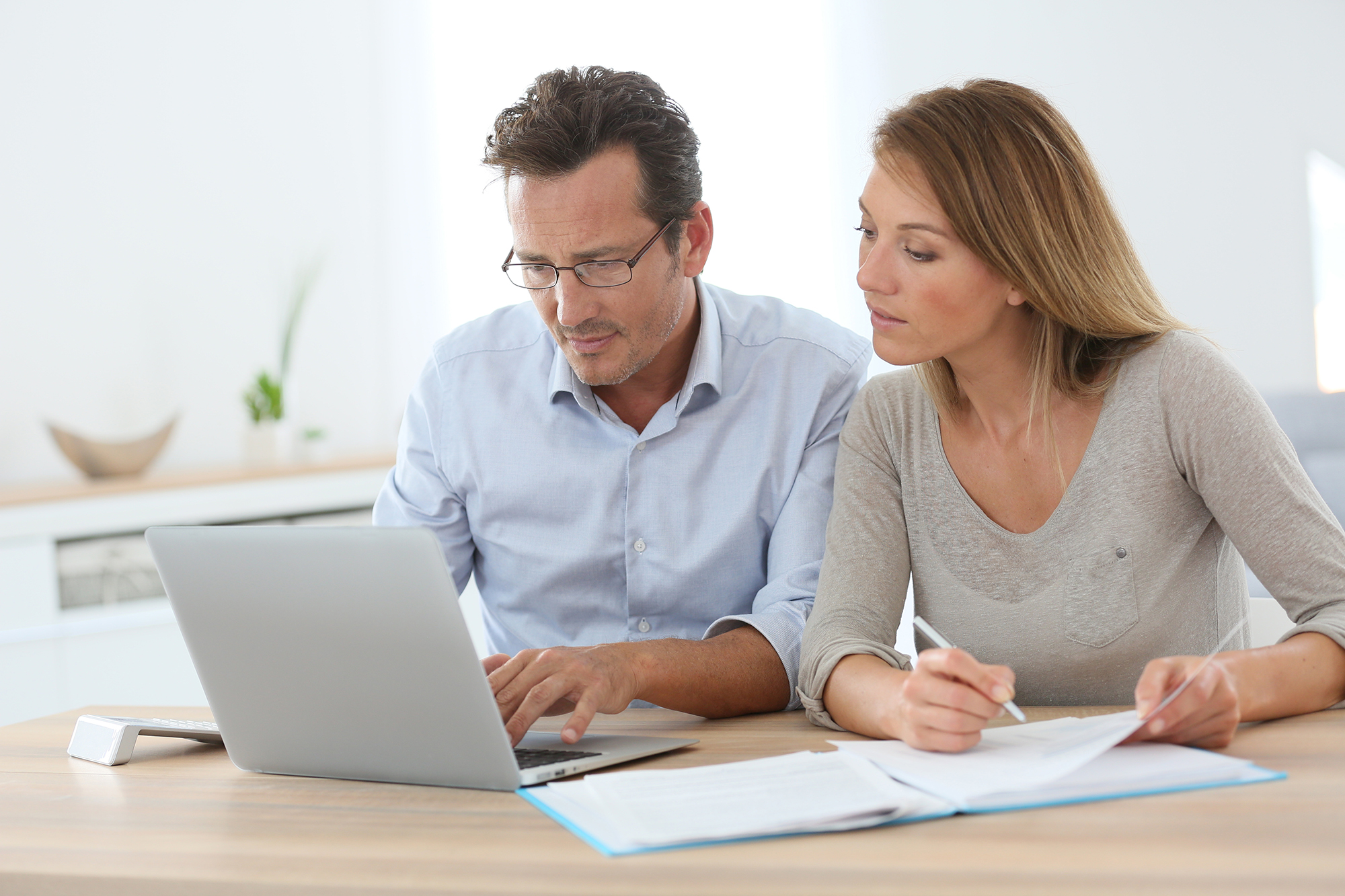 Couple viewing real estate listings on computer